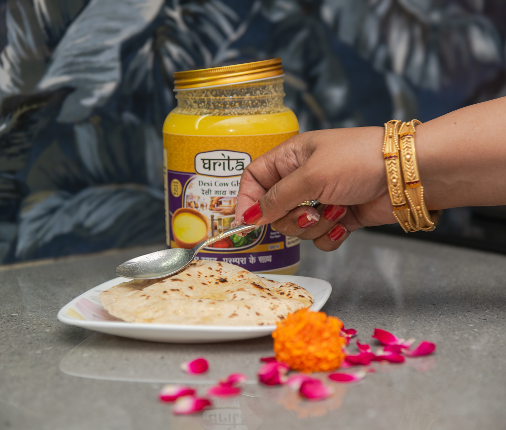 Pouring Ghrita A2 Desi Cow Ghee on chapati - health Indian meal