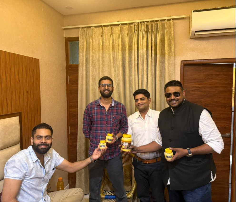 Team celebrating success with Ghrita A2 Desi Cow Ghee jars